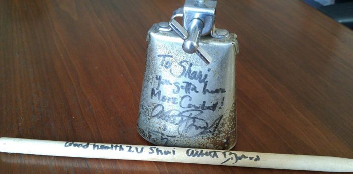 a cowbell with a signature sitting on a table