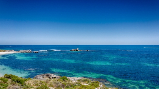 an island inlet with a clear blue sky and ocean