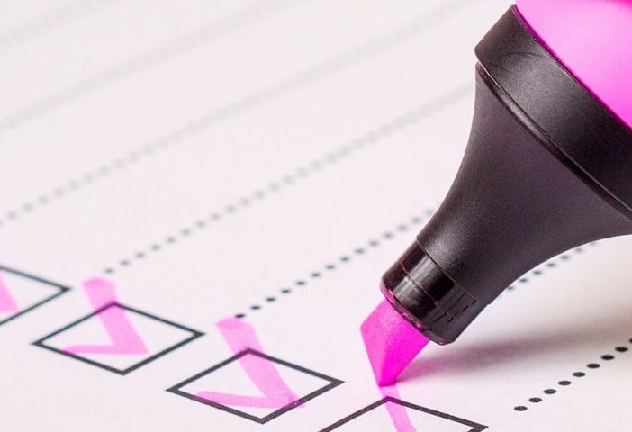 a person checking to do list with a pink highlighter